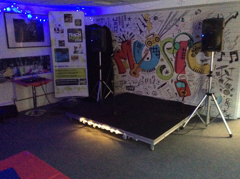image shows a Stage setup with speakers for the live music nights at House in the Basement Youth Cafe 2017. 