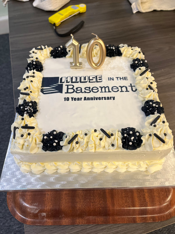 Image shows a cake to celebrate 10 years of House in the Basement Youth Cafe being open. 