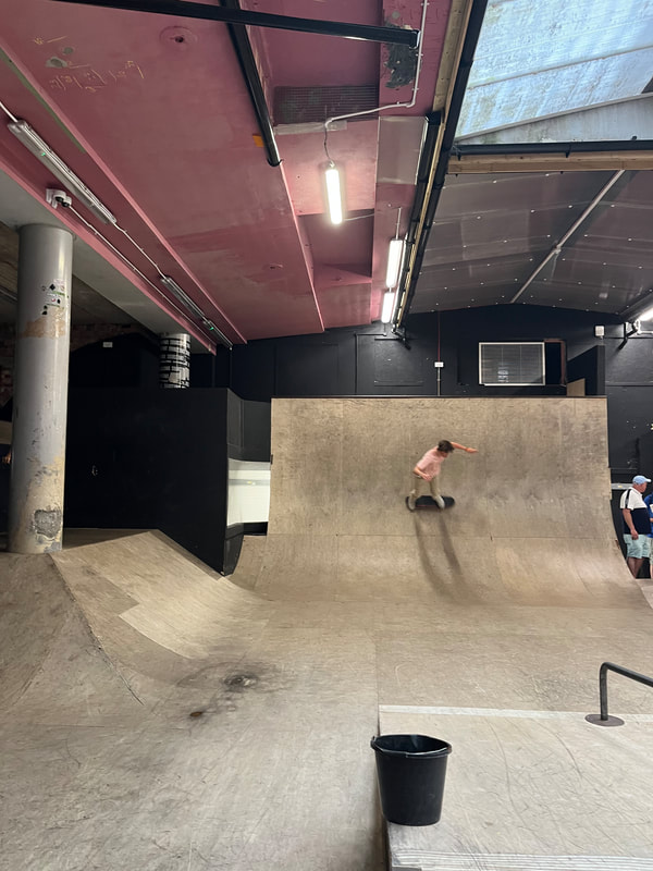 Image shows a Young person skating during a House in the Basement trip to Hastings indoor Skate Park