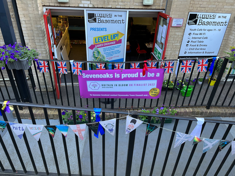 image show House in the Basements exterior decorated with bunting for Britain in Bloom.