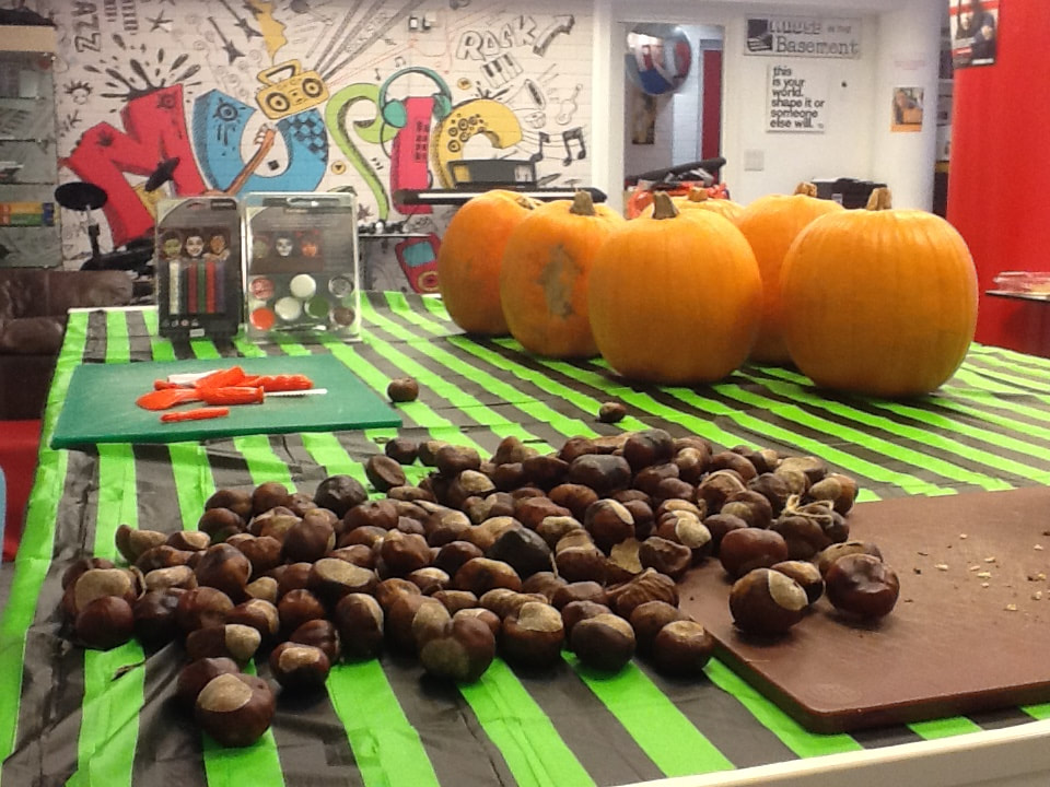 image shows pumpkins and chestnuts set up for a Halloween event at House in the Basement Youth Cafe.
